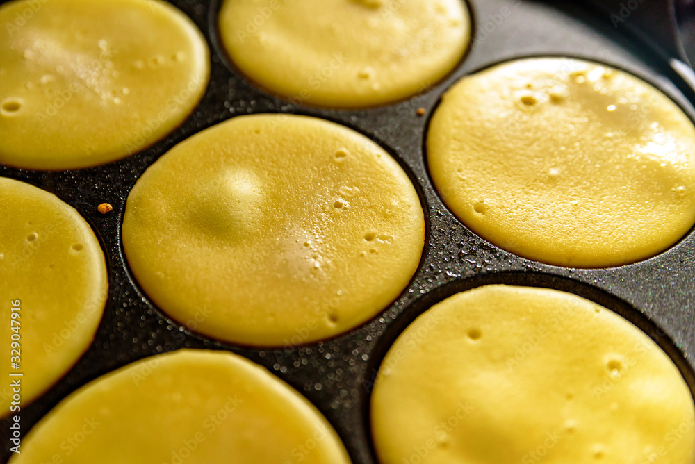 pancake frying pan with smile face pancake cooking on cooker in kitchen