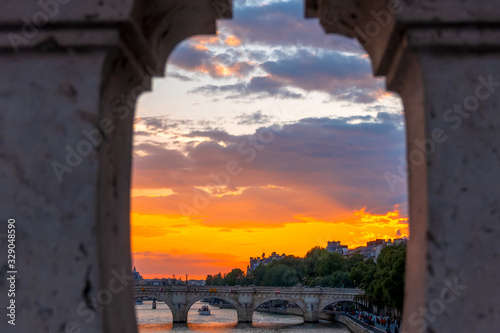 Sunset on the River Seine Through the Granite Fence of the Bridge