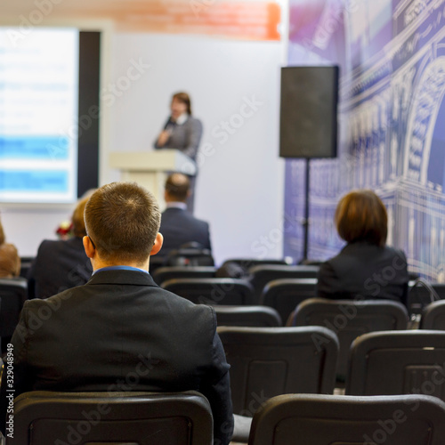 Wallpaper Mural the young man listens attentively to the lecturer at the conference. Back view Torontodigital.ca