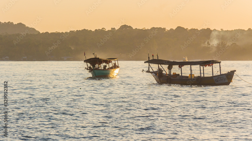 A sunset on Koh Rong island with two boats