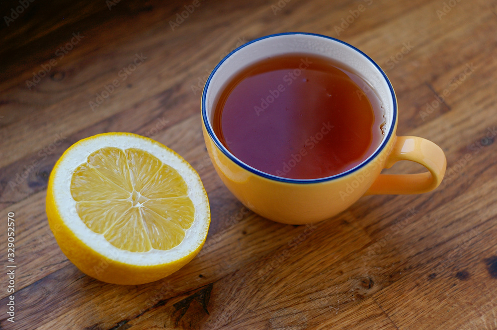 cup of tea and sliced lemon on a wooden table cup of tea and sliced lemon on a wooden table