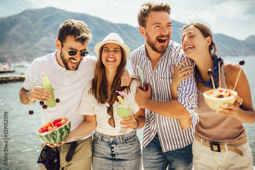 Photography Friends at the beach drinking cocktails having fun on summer vacation