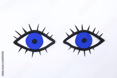 Pair of blue eyes with lashes on white background. Observig concept. Flat lay mockup. Ophthalmic background. photo