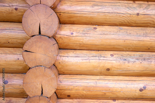 Round logs on wooden cabin house. Close up.