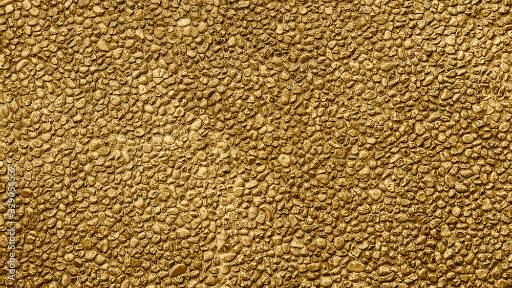 Golden pattern. Golden background and texture. Yellow gravel. Stone wall Golden pattern. Golden background and texture. Yellow gravel. Stone wall