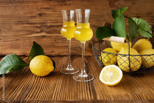 Limoncello liqueur and fresh lemons photo