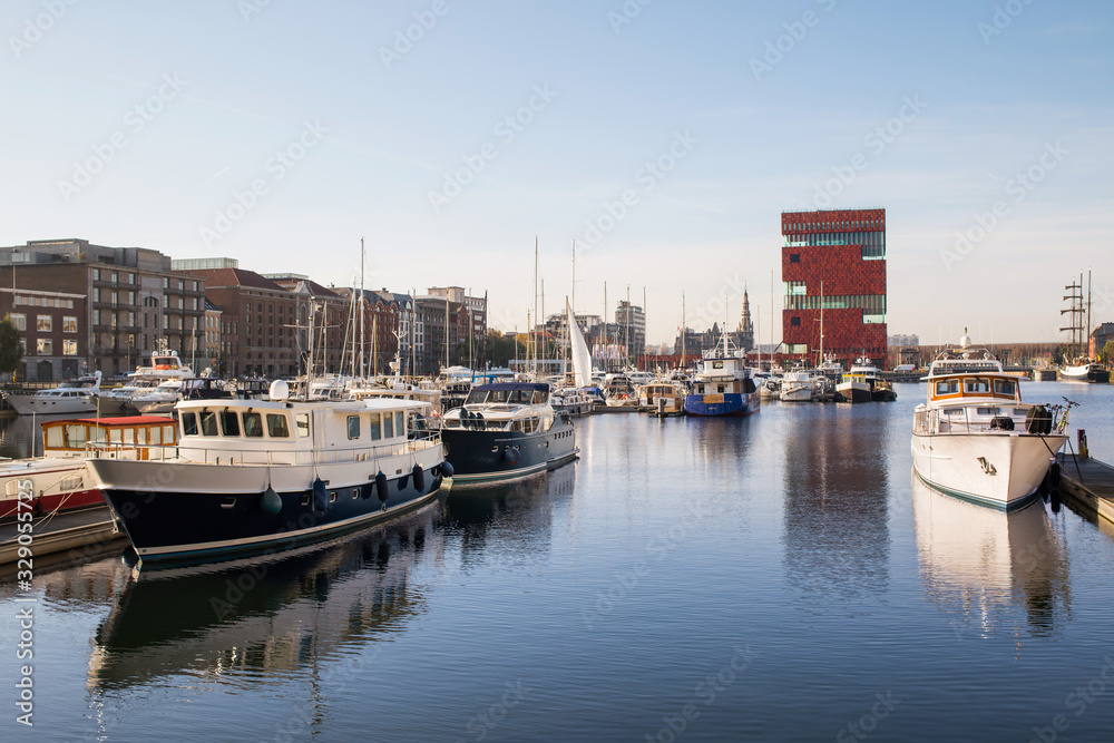 Antwerpen, Belgium, beautiful view of modern Eilandje area and port. Small island district and sailing marine at sunset. Popular travel destination and tourist attraction