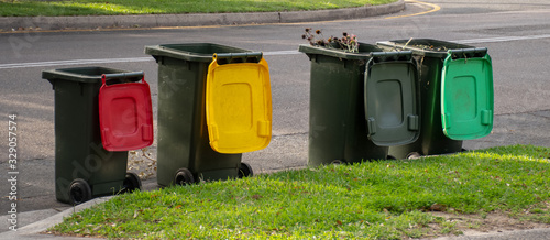 Fotografie Australian garbage wheelie bins with colourful lids for recycling household wast