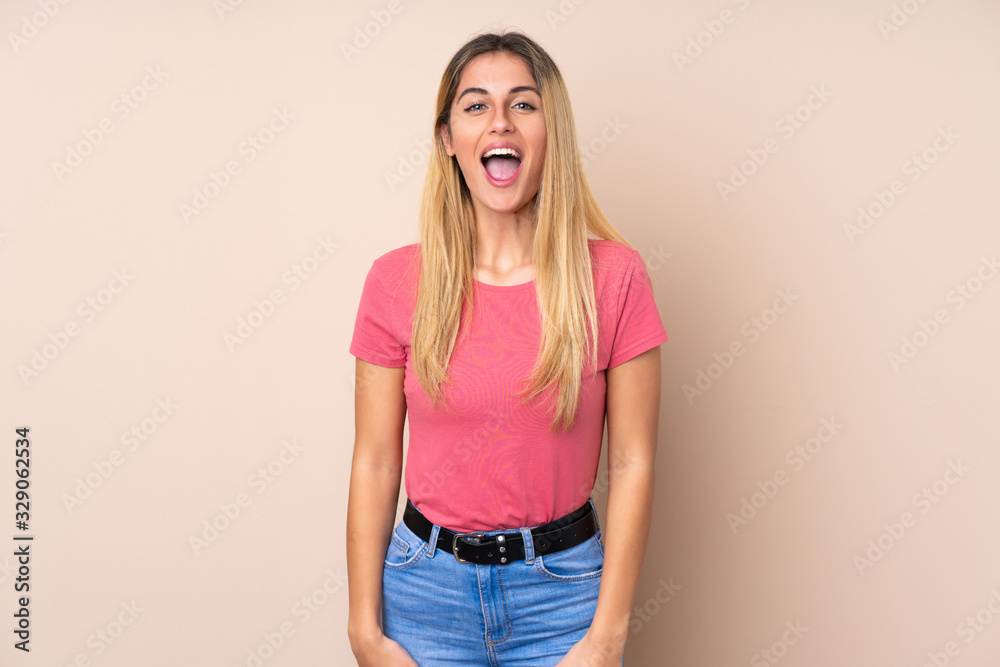 Young Uruguayan woman over isolated background shouting to the front with mouth wide open Young Uruguayan woman over isolated background shouting to the front with mouth wide open