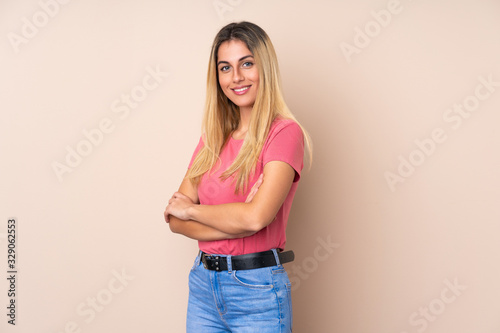 Young Uruguayan woman over isolated background with arms crossed and looking forward