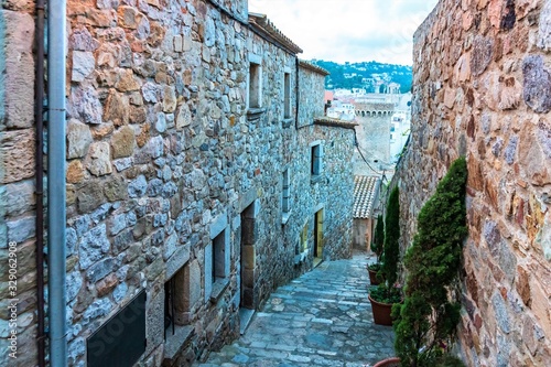 Fototapeta Naklejka Na Ścianę i Meble -  Tossa de Mar, Spain, August 2018. Narrow old street in the city fortress.