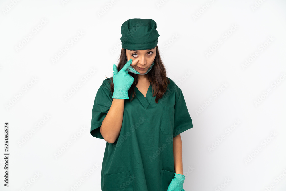 Surgeon woman in green uniform isolated on white background showing something Surgeon woman in green uniform isolated on white background showing something