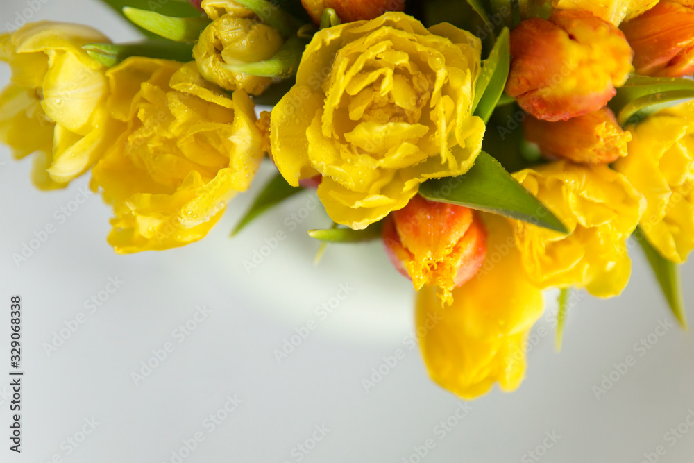 Bouquet of yellow and red tulips on a white background.