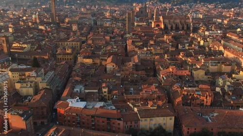 aerial view of bologna city center at sunrise tilt up drone flying over old town revealing shot photo
