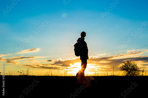 Fototapeta Naklejka Na Ścianę i Meble -  Girl hiking in silhouette over the sky