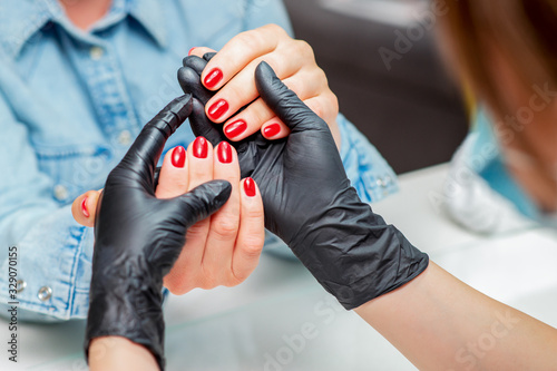 Woman receiving manicure.