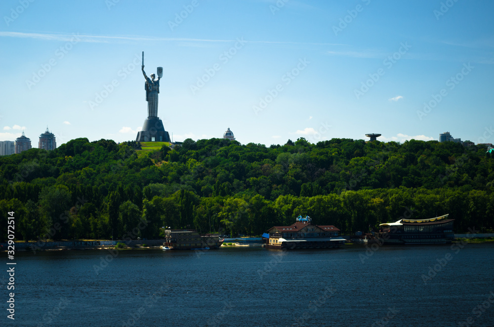 Panorama of the city of Kiev, view of the monument Motherland. Construction of a new arch bridge over the river. The capital of ancient Russia. Kiev, Ukraine, July 4, 2016