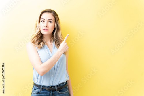 Serious Woman In Casual Is Pointing With Index Finger