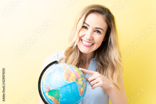 Happy Woman Is Pointing At World Map
