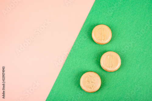Three gingerbread in the navof of money on an abstract background of different colors.
