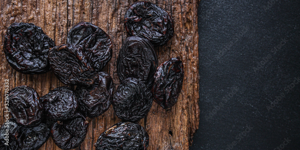 prunes, dried plums (tasty and healthy fruits) desiccated keto or paleo diet menu concept. background. top view. copy space prunes, dried plums (tasty and healthy fruits) desiccated keto or paleo diet menu concept. background. top view. copy space
