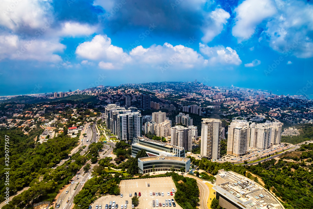 Panoramic view of Haifa - bay, downtown, residential and university buildings in a sunny summer day from Eshkol Tower, the highest point of Haifa University on the Mount Carmel, Israel Panoramic view of Haifa - bay, downtown, residential and university buildings in a sunny summer day from Eshkol Tower, the highest point of Haifa University on the Mount Carmel, Israel