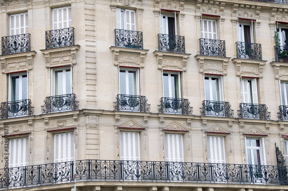 Windows and Iron balconies of old apartment buildings in Paris France