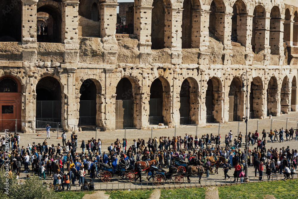 ROME, ITALY- MARTCH 03, 2019: Many people walk around the Colosseum, ancient city Rome. Tourists visit the Colosseum in Italy, Europe. 