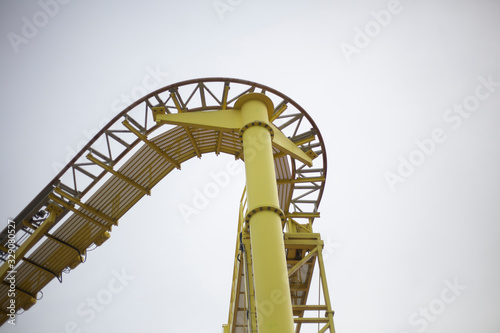 A roller coaster in an amusement park. Relax in fun amusement. Fun for the townspeople. Rail-type metal construction for accelerating the trolley. Fun in the amusement park.