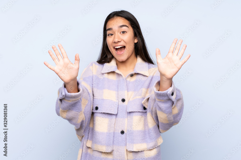 Young Indian woman isolated on blue background counting ten with fingers Young Indian woman isolated on blue background counting ten with fingers