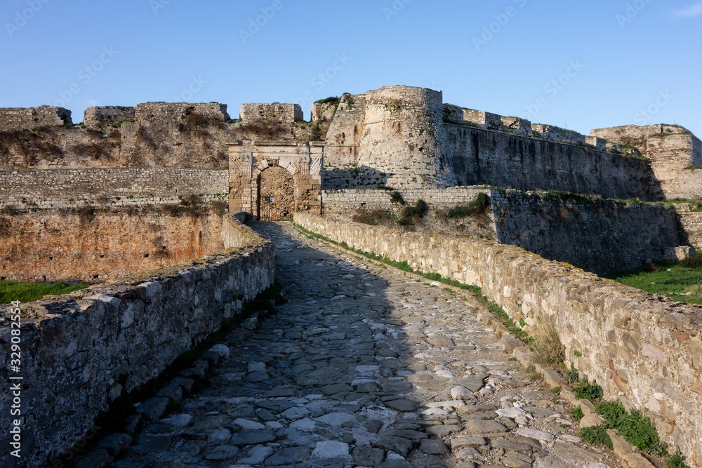 Entrance to the ancient Methoni Castle in Greece with a stone bridge in sunny morning
