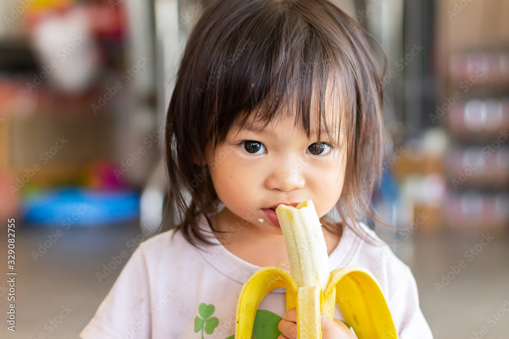 child eating banana