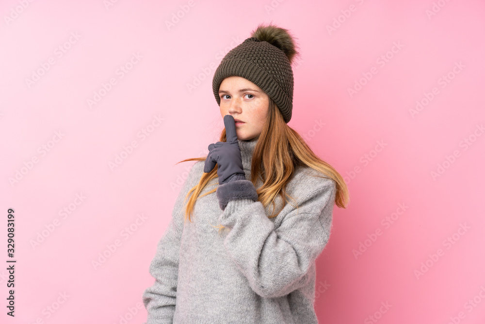 Ukrainian teenager girl with winter hat over isolated pink background doing silence gesture Ukrainian teenager girl with winter hat over isolated pink background doing silence gesture
