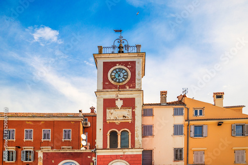 A red clock tower at The Marsala Tita Square in Rovinj town, Croatia, Europe.