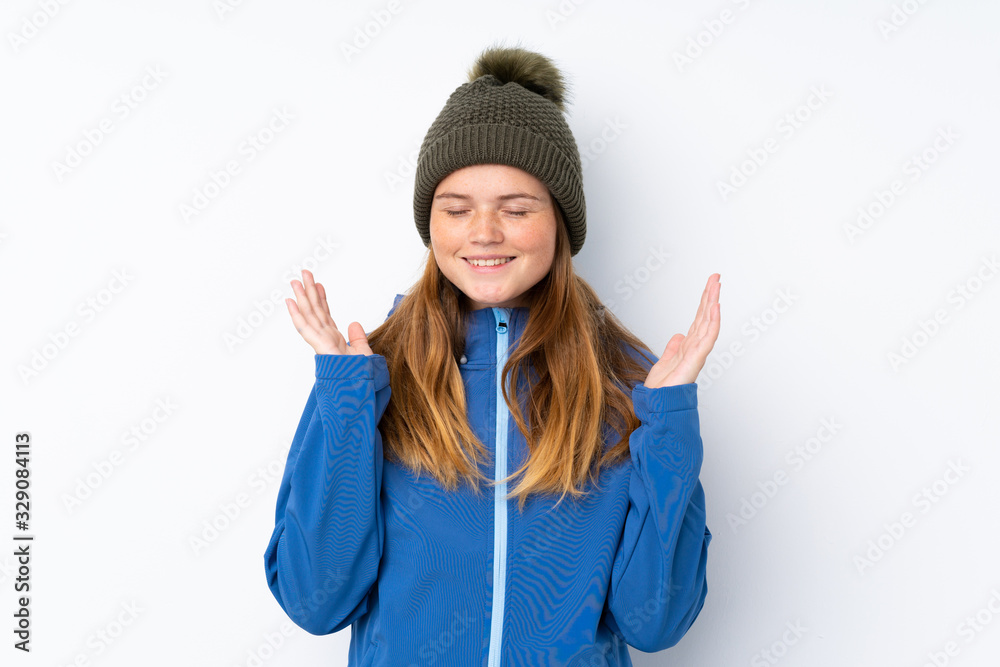 Ukrainian teenager girl with winter hat over isolated white background laughing Ukrainian teenager girl with winter hat over isolated white background laughing