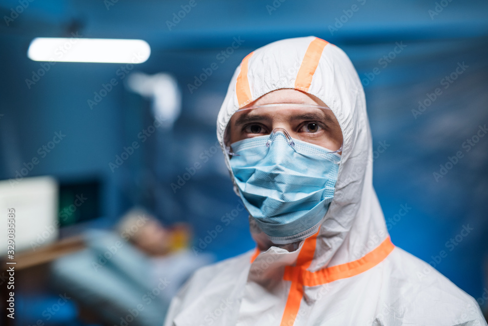 Man with protective suit and face mask indoors, coronavirus concept. - obrazy, fototapety, plakaty 