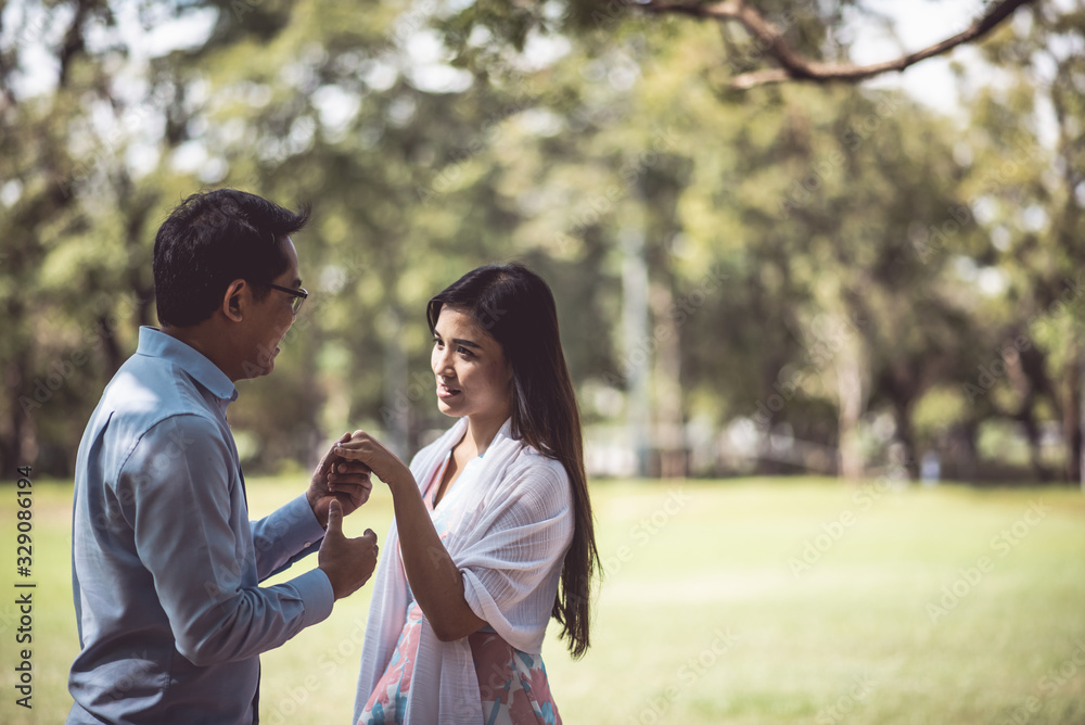 Fototapeta premium Romantic Couple Standing On Field At Park