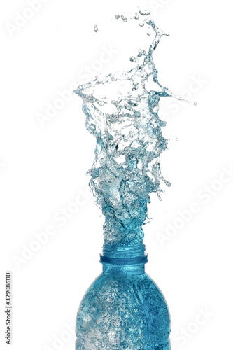 isolated of water splashing form the bottle on white background.