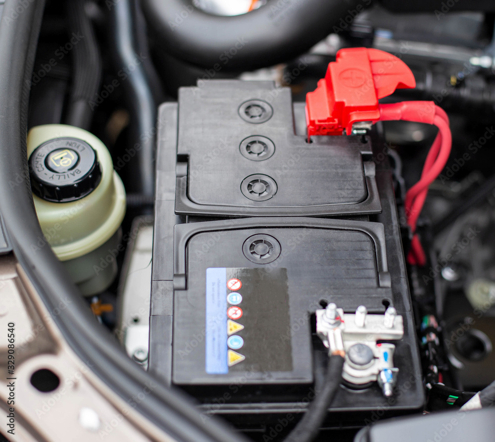 the battery in the car in the engine compartment, background, accumulator battery the battery in the car in the engine compartment, background, accumulator battery