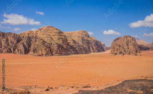 Wadi Rum picturesque desert scenic top view orange sand valley and beautiful huge rock mountain ridge vivid colorful
