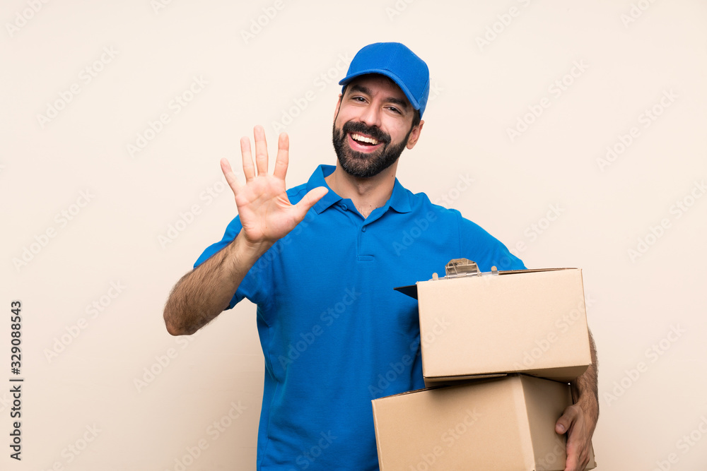 Delivery man with beard over isolated background counting five with fingers Delivery man with beard over isolated background counting five with fingers