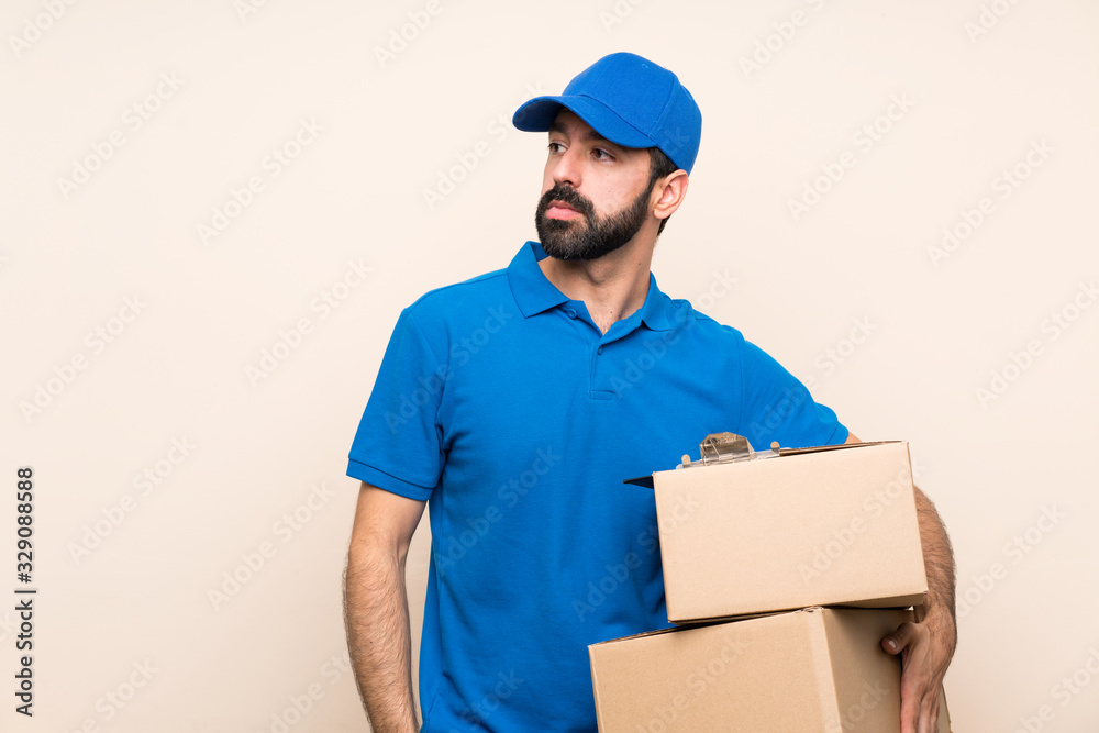 Delivery man with beard over isolated background portrait Delivery man with beard over isolated background portrait