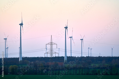 Wind turbines on countryside wind park at sunset photo