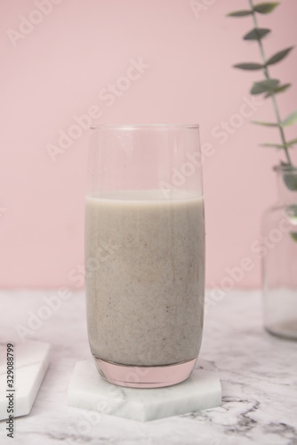 The motile protein on the spoon and in the bottom glass against the marble background