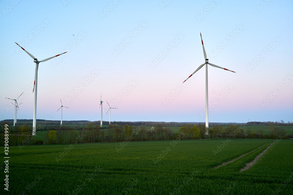 Wind turbines on countryside wind park at sunset Wind turbines on countryside wind park at sunset
