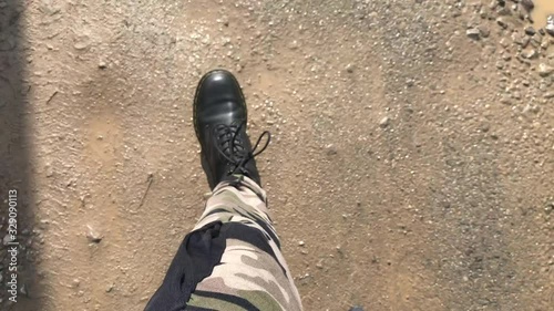 Man in camouflage pants walking