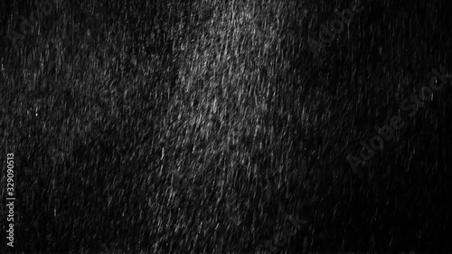 Heavy droplets of rain falling on an isolated background 