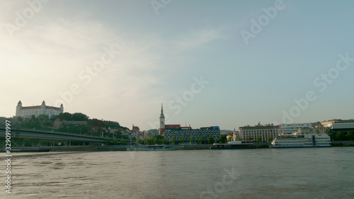 Photography Capital of Slovakia - Bratislava Cityline with Castle, Church Tower, Car SNP Bridge over Danube River at Summer Sunset