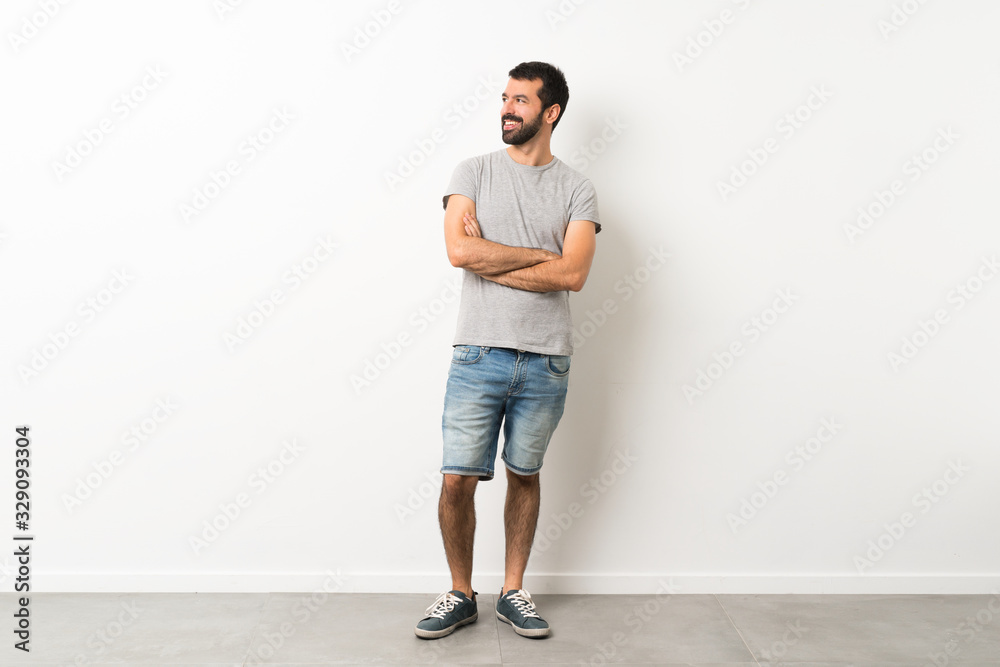 A full-length shot of handsome man with beard happy and smiling A full-length shot of handsome man with beard happy and smiling