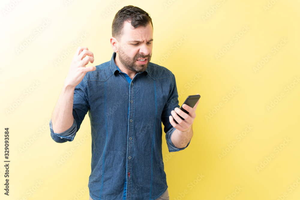 Hispanic Man Is Annoyed With Mobile Phone Hispanic Man Is Annoyed With Mobile Phone